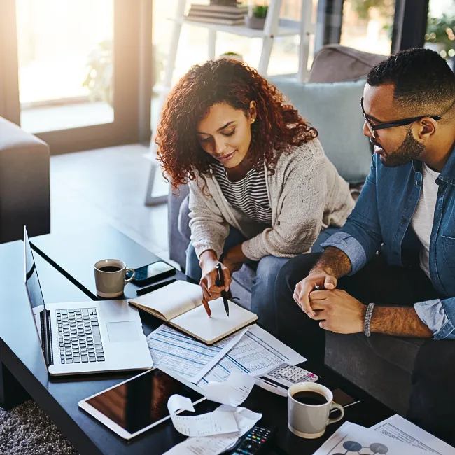  A couple reviewing their financial goals with a checklist